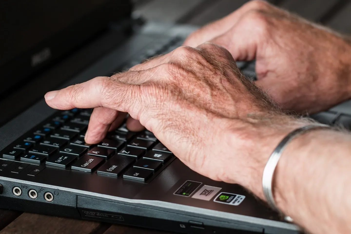 Close up of hands on a keyboard.
