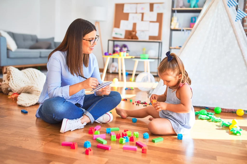 A home health aide playing with a child.
