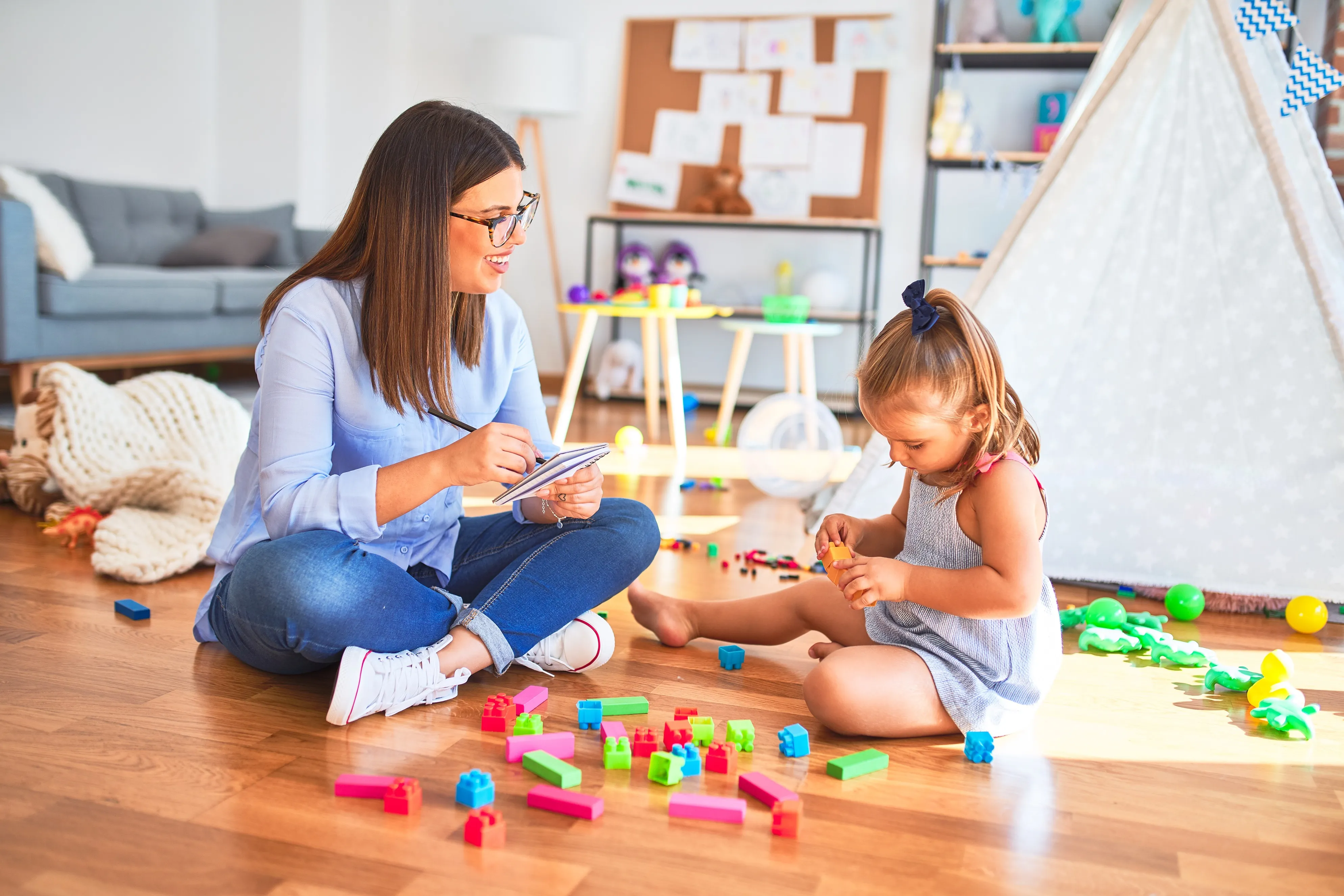 A home health aide playing with a child.
