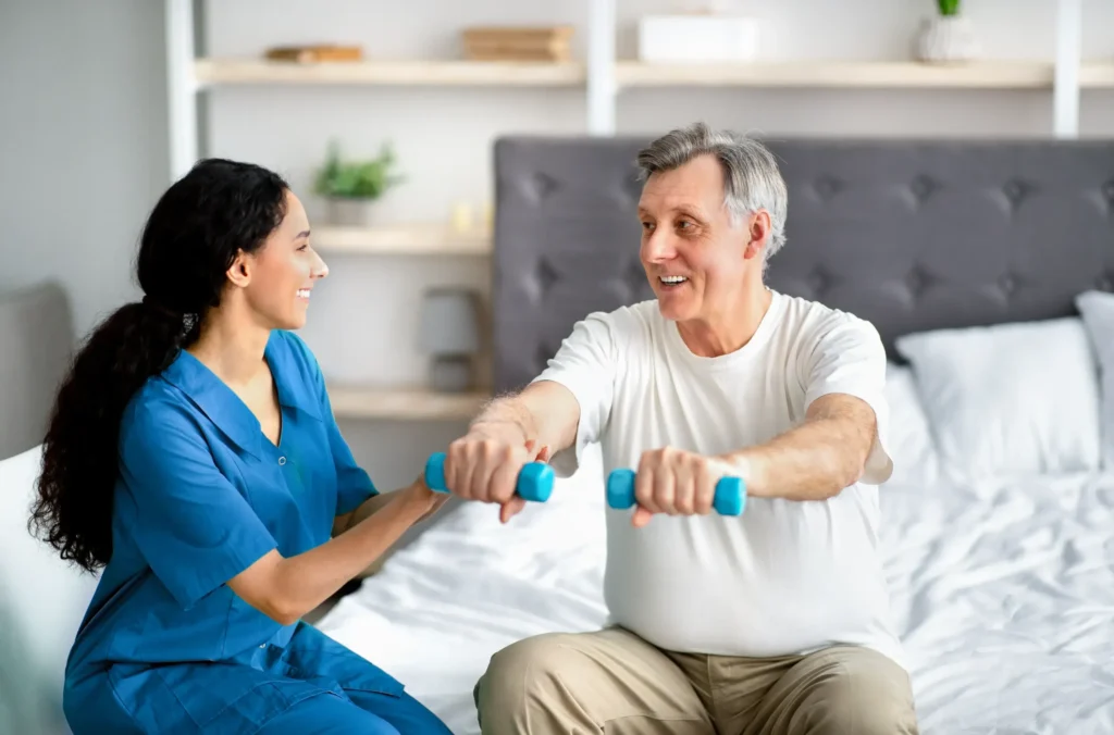 A home healthe aide helping her patient lift weights.